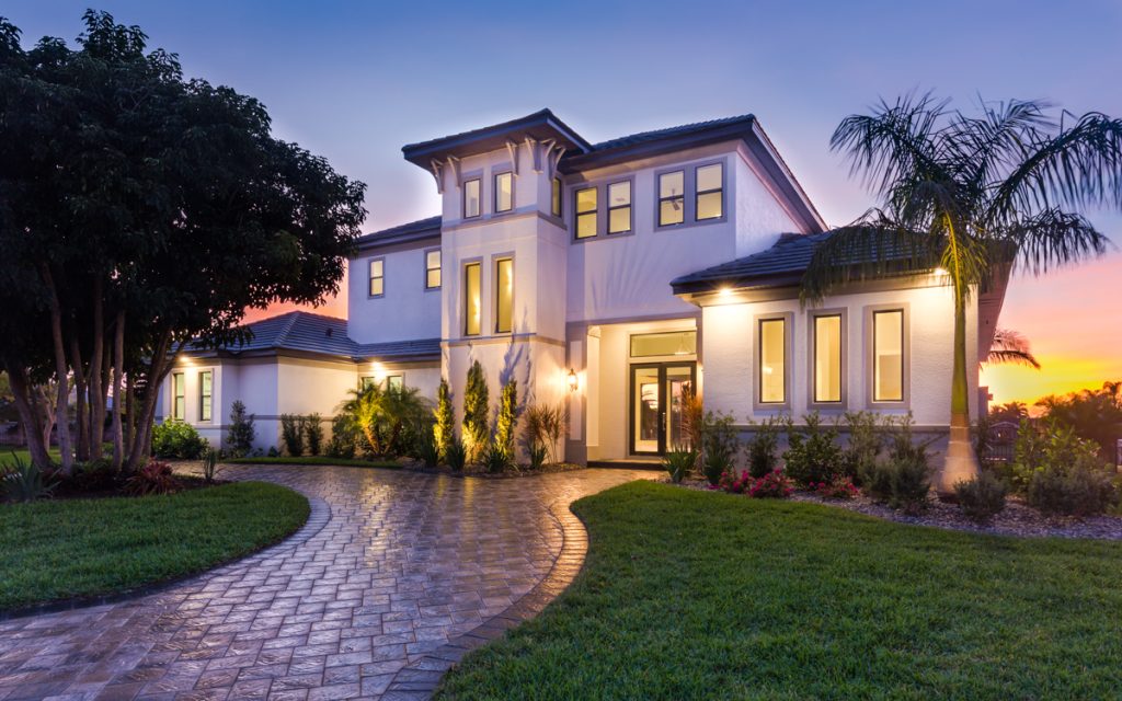 Exterior of a transitional style two-story custom home built by Aubuchon Homes in Town and River in Fort Myers, FL. 